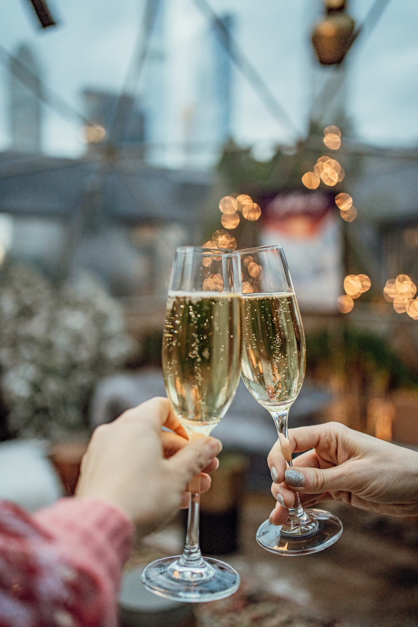 Two glasses of champagne clinking at an evening celebration, generic stock photo pending real venue photography.