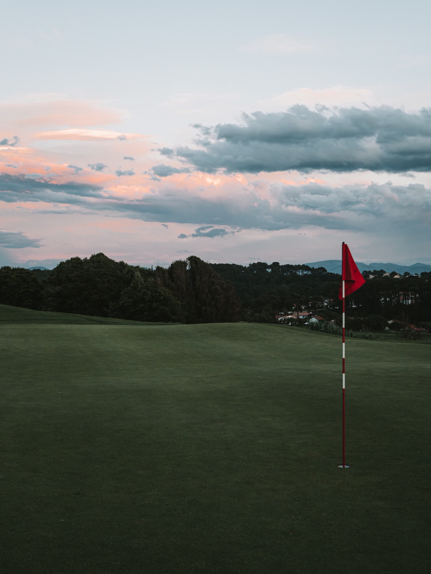 A golf flag at sunset, generic stock photo pending real venue photography.